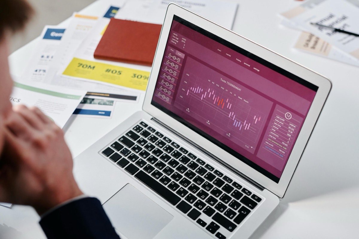 Reviewing data analytics on a laptop in an office